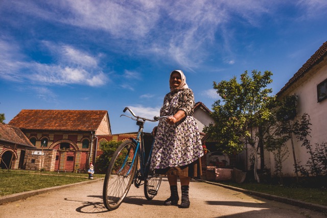 Granny with a bike in Croatian countryside - genuine sight of immersive Croatia travel